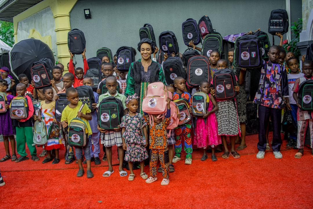 Judith Ogbara sharing school bags and learning materials with students in Eket